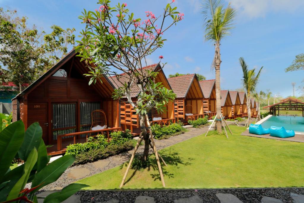 an image of a resort with a pool and a yard at Bingin Lodge Uluwatu in Uluwatu
