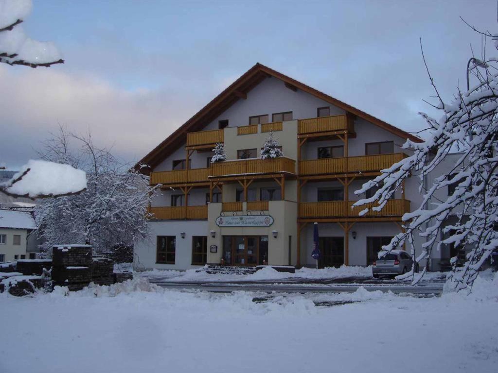 a large building with snow in front of it at Rhöner Landhotel Haus zur Wasserkuppe in Ehrenberg