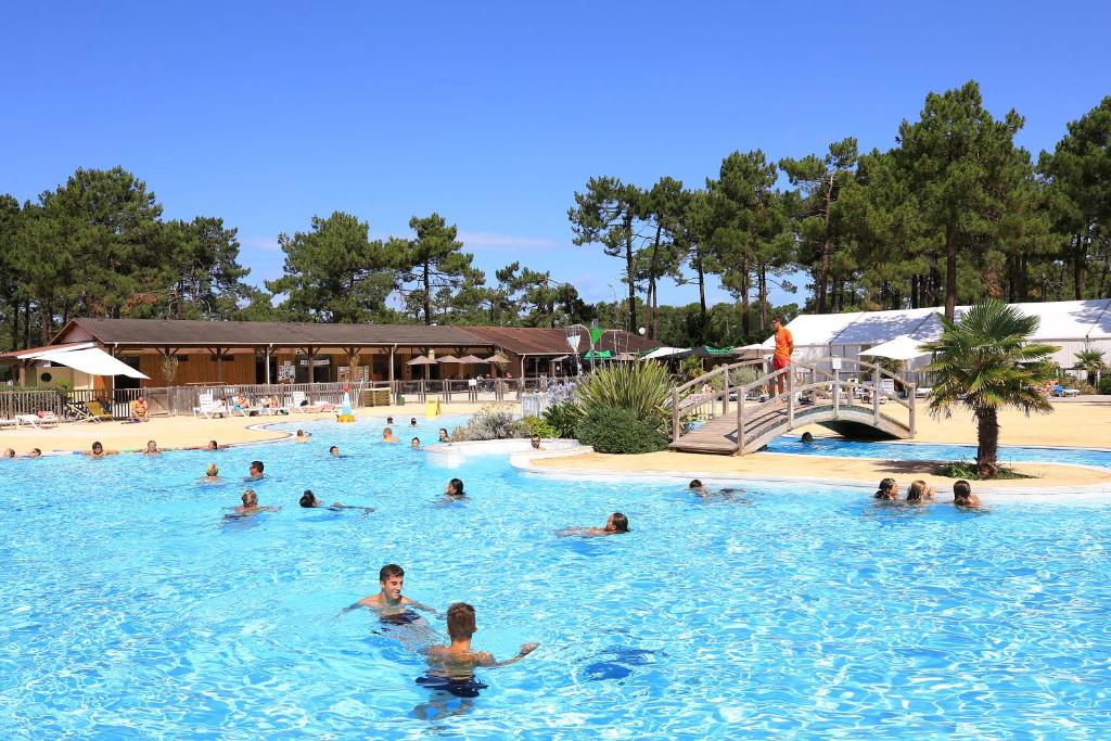 a group of people swimming in a swimming pool at Camping Campéole Médoc-Plage - Maeva in Vendays-Montalivet