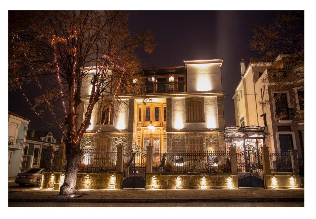 a large house with lights in front of it at night at Vila EKREM in Korçë
