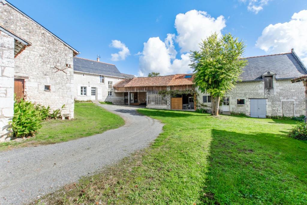 an old farmhouse with a gravel road in front of it at Maison de 3 chambres avec jardin clos et wifi a Assay in Assay