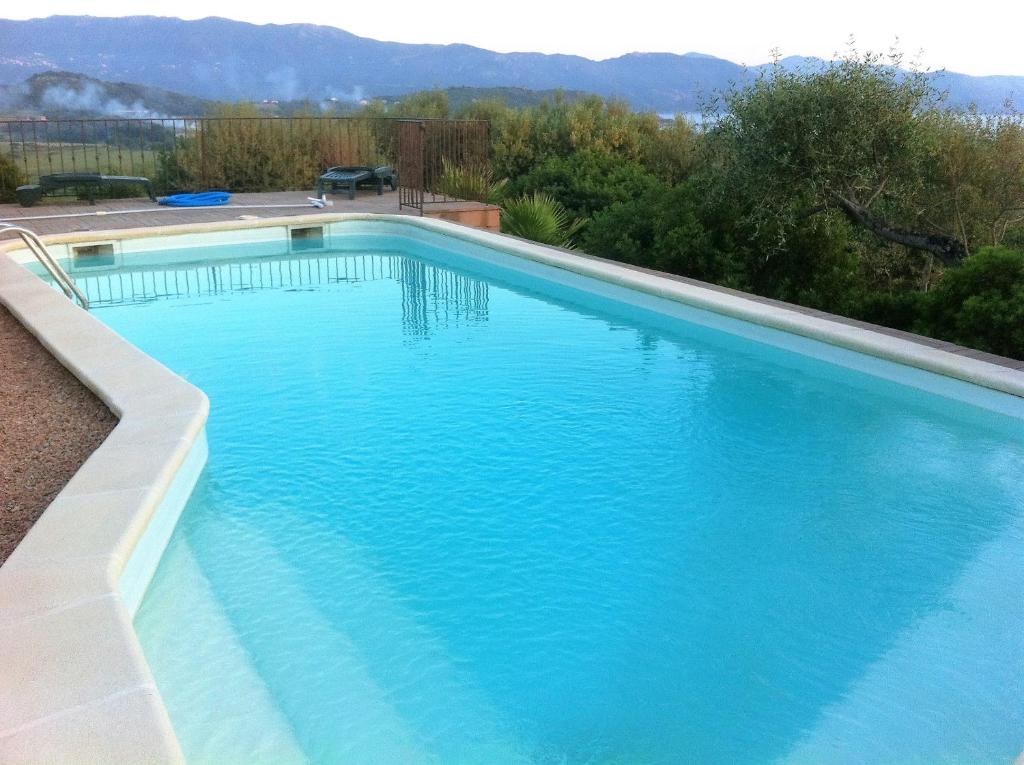 une grande piscine d'eau bleue dans l'établissement Villa de 4 chambres avec vue sur la mer piscine privee et jardin clos a Sagone a 1 km de la plage, à Sagone