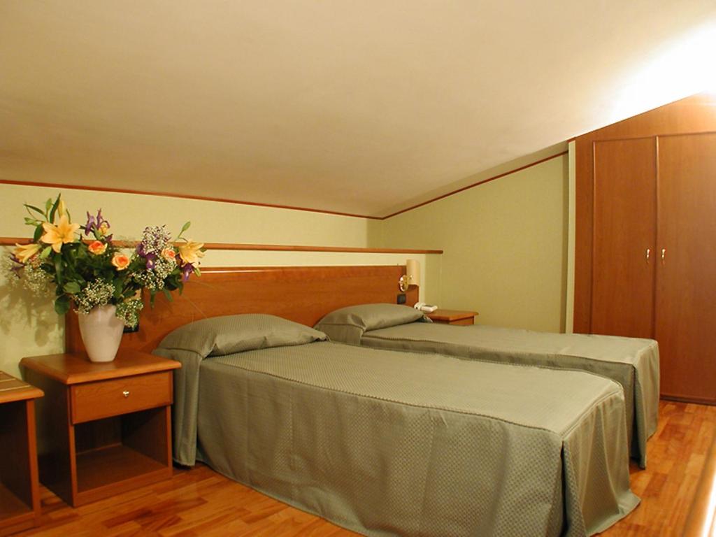 Postel nebo postele na pokoji v ubytování Hotel Dimora Adriana