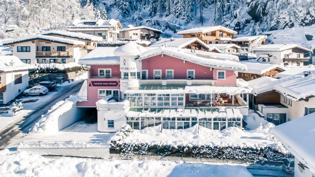 a town covered in snow with houses at Apart Relax in Längenfeld