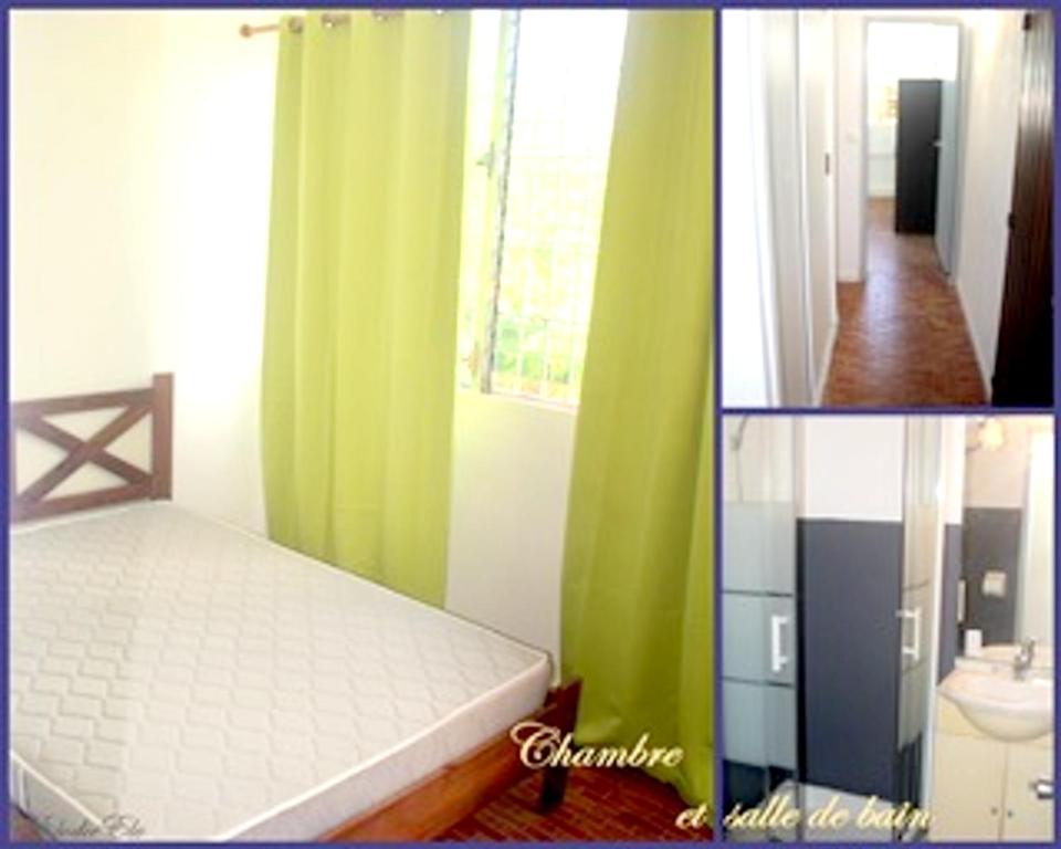 a bedroom with green and white curtains and a bed at Appartement moderne à Les Trois Ilets, 40 m², vue jardin in Les Trois-Îlets