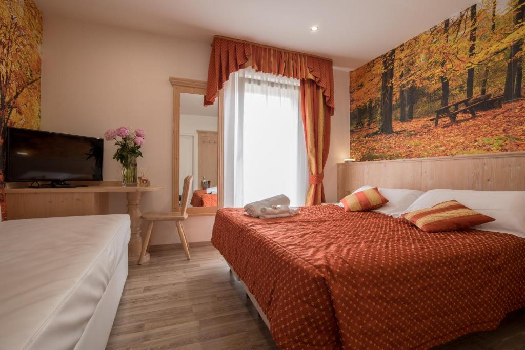 Postel nebo postele na pokoji v ubytování Hotel Touring