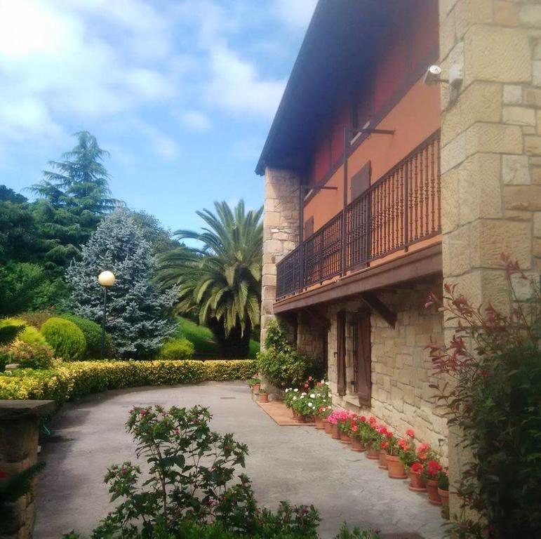 a building with a balcony and flowers in a courtyard at 7 bedrooms house with furnished terrace and wifi at Gamiz Fica in Fica