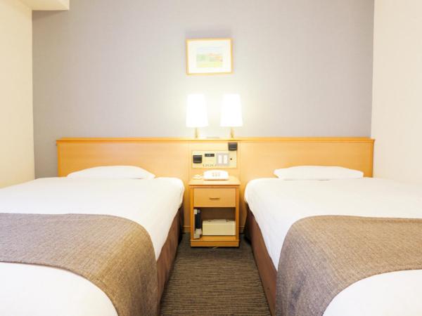 Postel nebo postele na pokoji v ubytování Smile Hotel Wakayama
