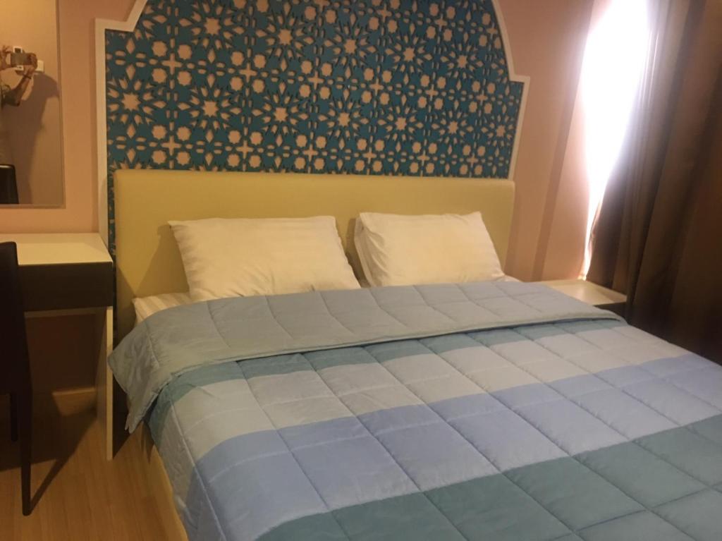 Llit o llits en una habitació de Bluroc Hua Hin Apartment