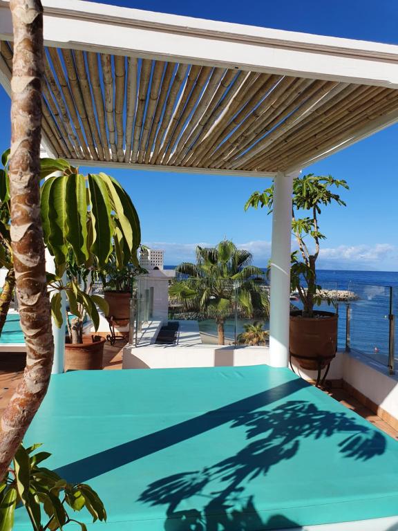 an outdoor swimming pool with a view of the ocean at Flamingo Beach Mate in Adeje