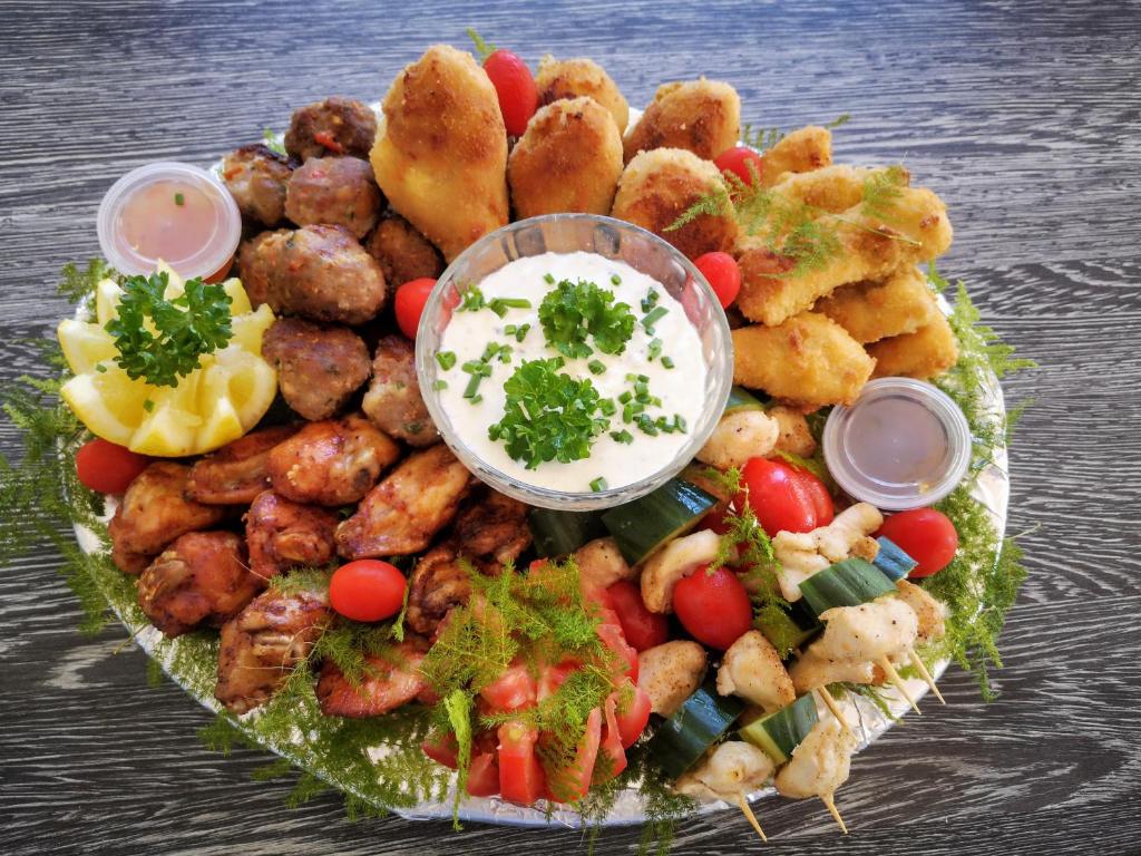 a platter of food with meatballs and other foods at Diamond House Guesthouse in Cape Town