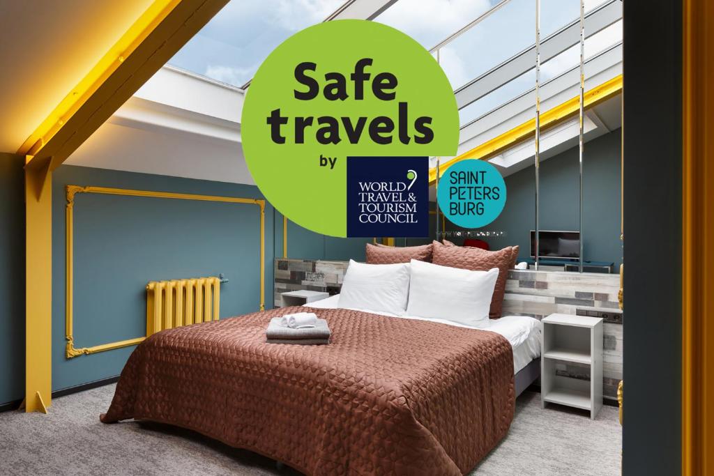 a bedroom with a bed and a sign that reads safe travels at Station Hotel Premier S10 in Saint Petersburg