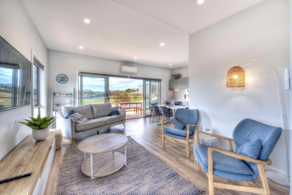 a living room with a couch and chairs and a table at Archella 2 in Coles Bay