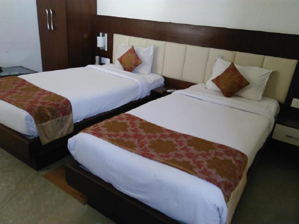 Postel nebo postele na pokoji v ubytování Hotel Taj Heights