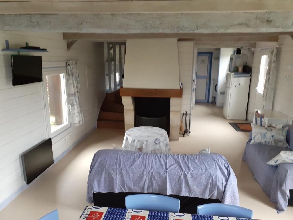 a living room with a table and a couch at Gîtes Manoir du Buquet in Honfleur