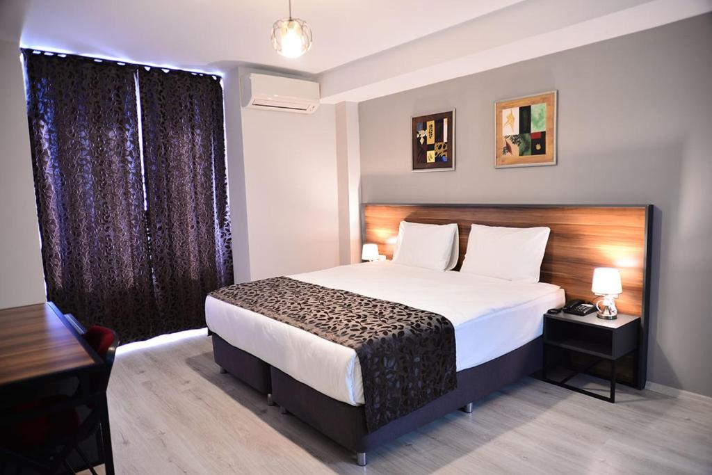 En eller flere senge i et værelse på PRIVADO HOTELS