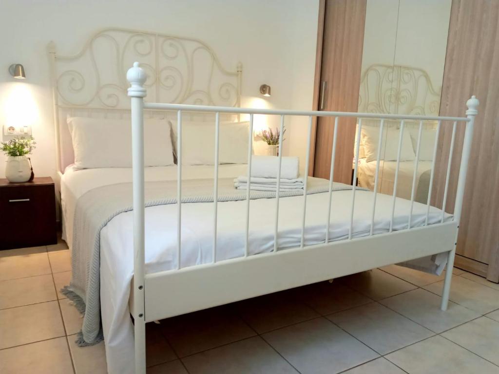 a bedroom with a white bed with white sheets at MNG-Apart Aloha Garden Costa Adeje in Adeje