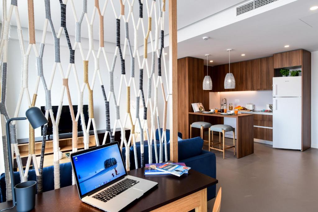 A laptop-ready desk overlooking the apartment’s lounge and kitchen.
