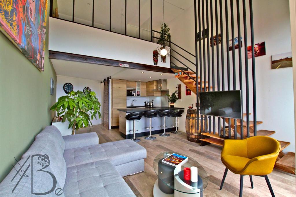 a living room with a couch and a kitchen at residence de porticcio, youyoube in Porticcio