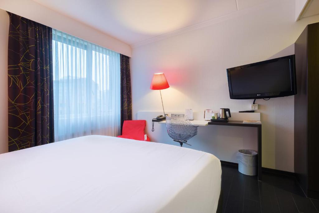 Postel nebo postele na pokoji v ubytování Postillion Utrecht Bunnik