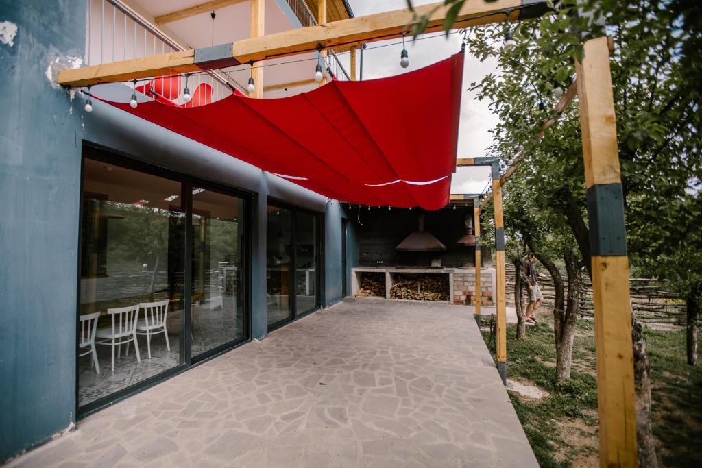 a red umbrella hanging from the side of a building at Vardeni Guesthouse in Hrazdan