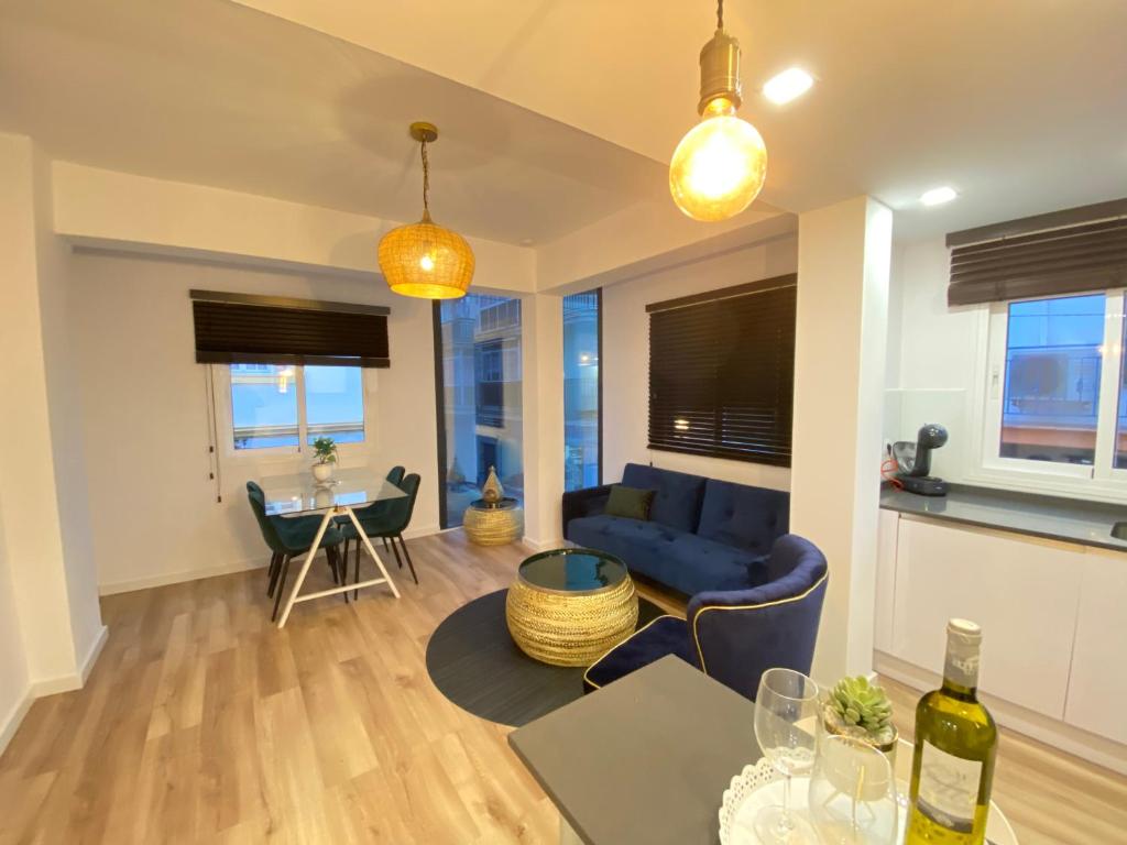 a living room with a blue couch and a table at Apartamentos palangreros in Fuengirola