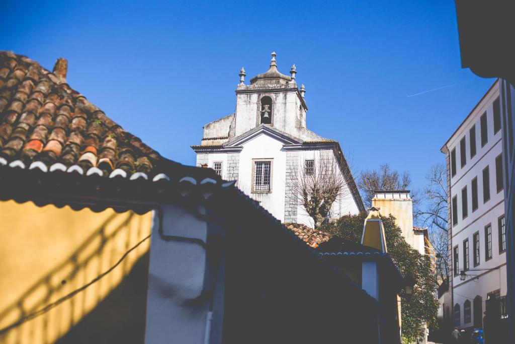 a building with a clock tower in a city at Sintra1012 Boutique Guesthouse in Sintra