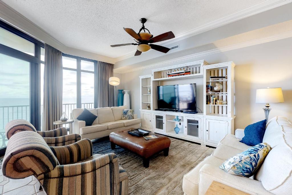 a living room with a couch and a tv at Phoenix West in Orange Beach