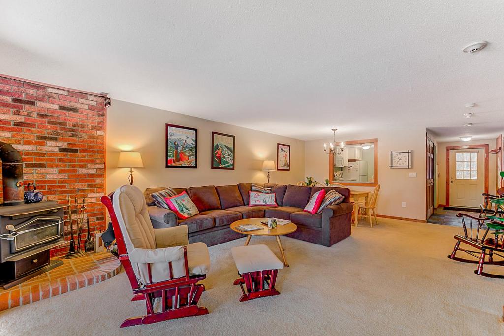 a living room with a couch and a brick wall at 24 Northface Circle in North Conway