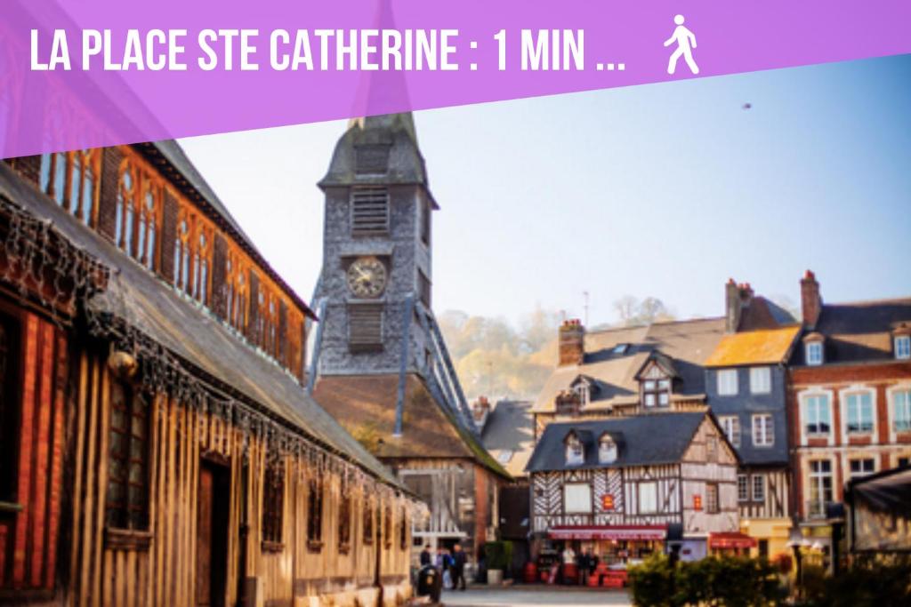 a picture of a town with a clock tower at Le Studio du Gouverneur in Honfleur