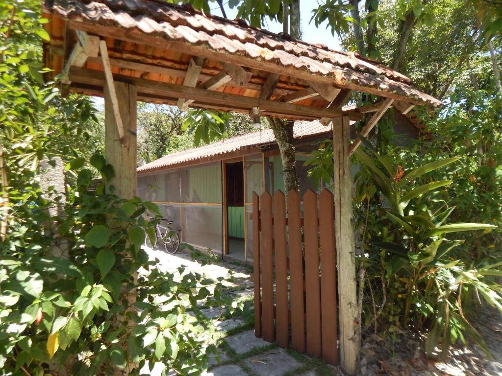a wooden gate in front of a house at Residencial Brisa da Ilha do Mel in Ilha do Mel