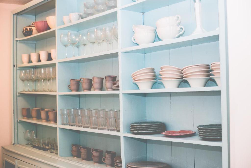 a shelf filled with dishes and bowls and plates at Sintra1012 Boutique Guesthouse in Sintra