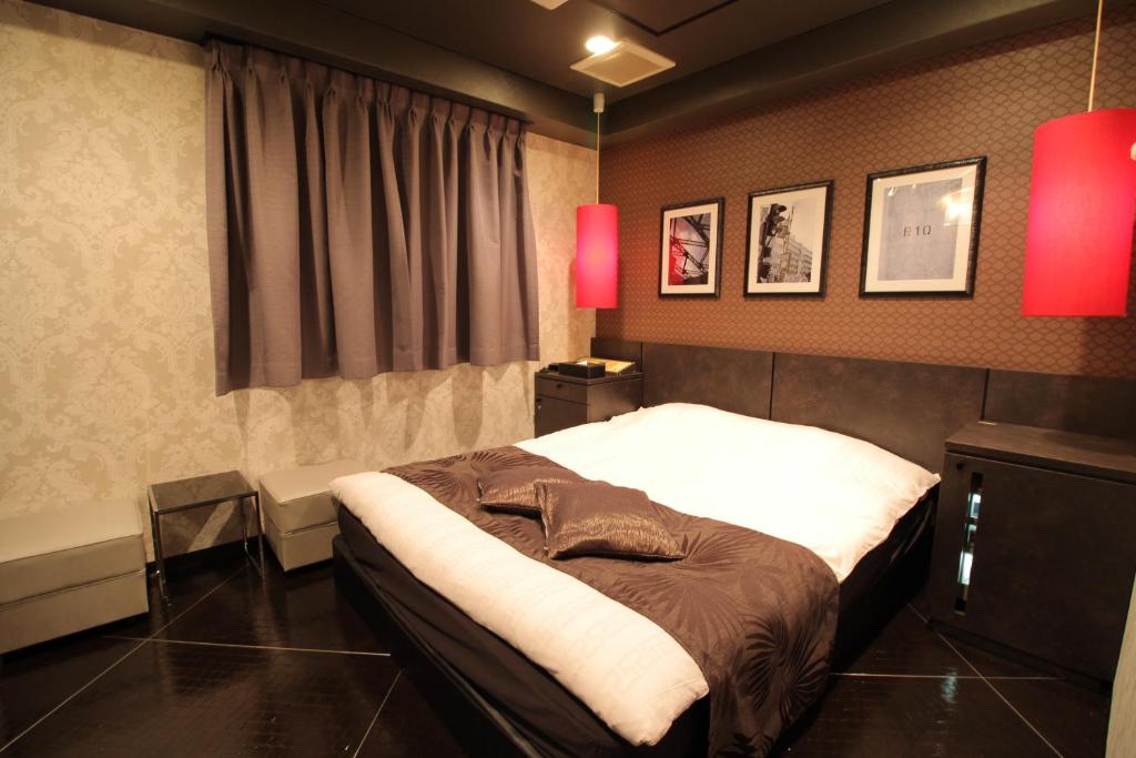 Voodi või voodid majutusasutuse Hotel K Omiya (Adult Only) toas