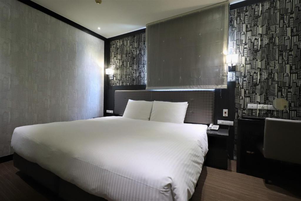 Postel nebo postele na pokoji v ubytování J-HOTEL