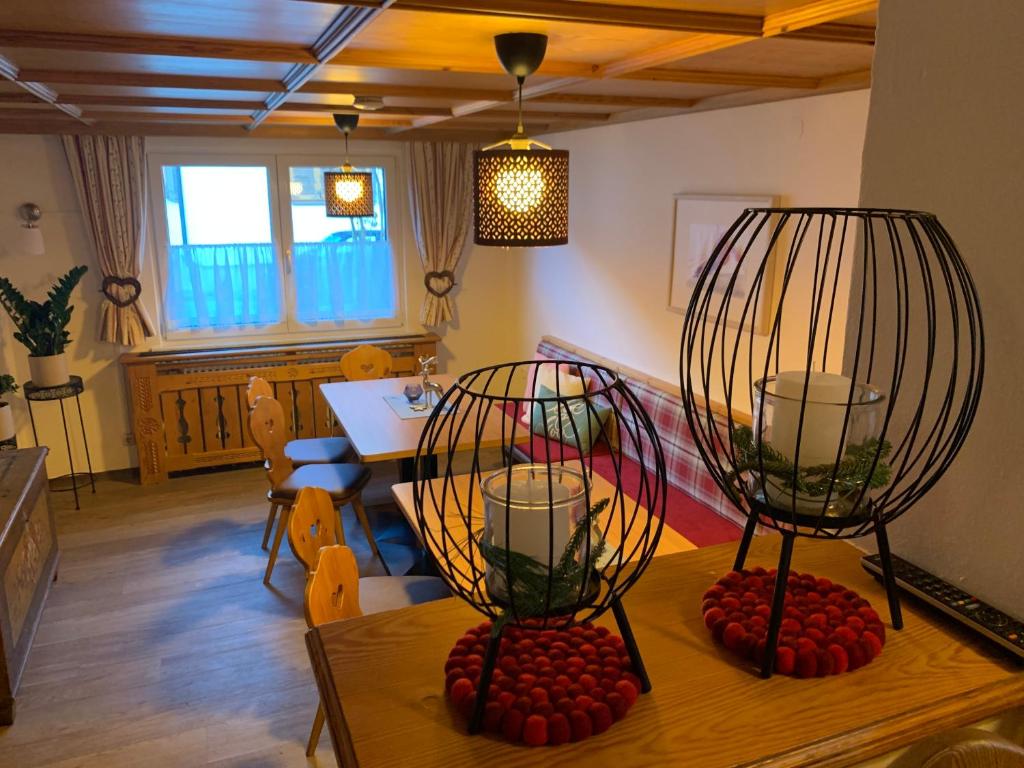 a dining room with a table with two candles on it at Chalet Rosanna in Sankt Anton am Arlberg