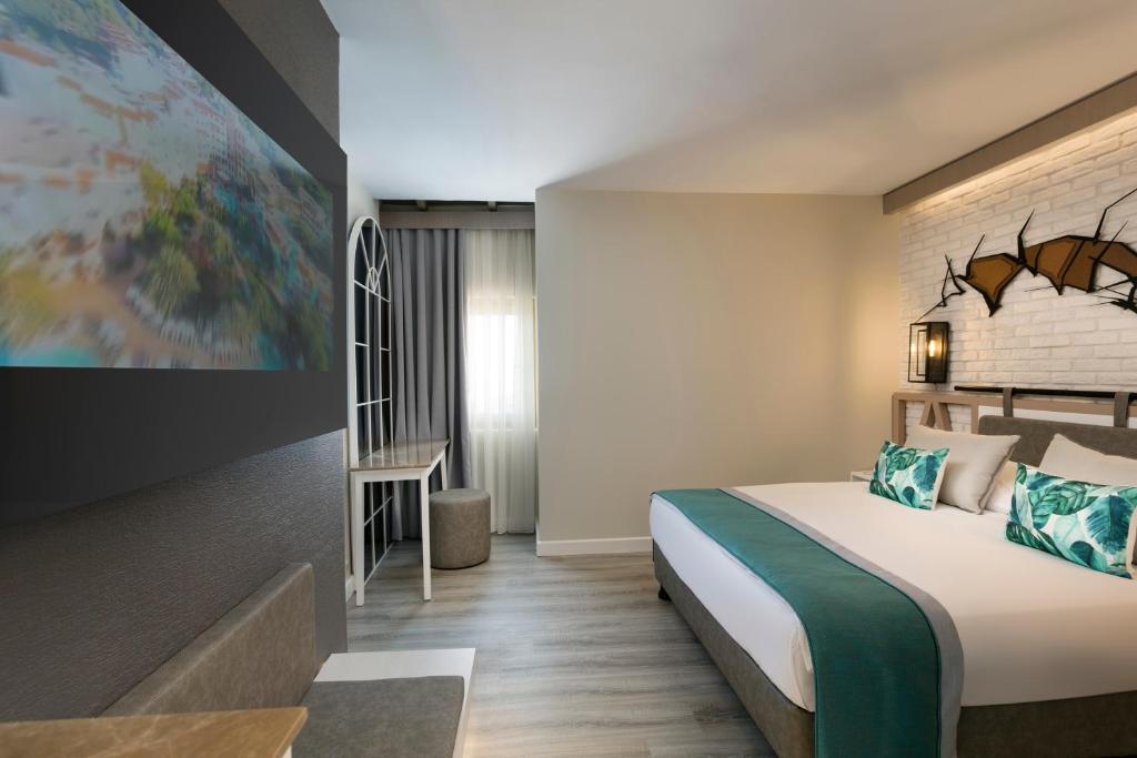 a hotel room with a bed and a map on the wall at Limak Arcadia Sport Resort Belek in Belek
