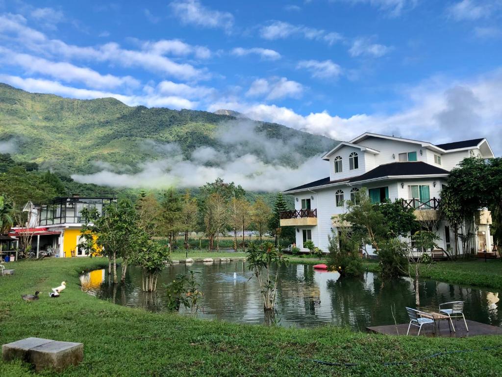 a group of houses next to a river at Tree Lake B&B Hualien in Shuhu