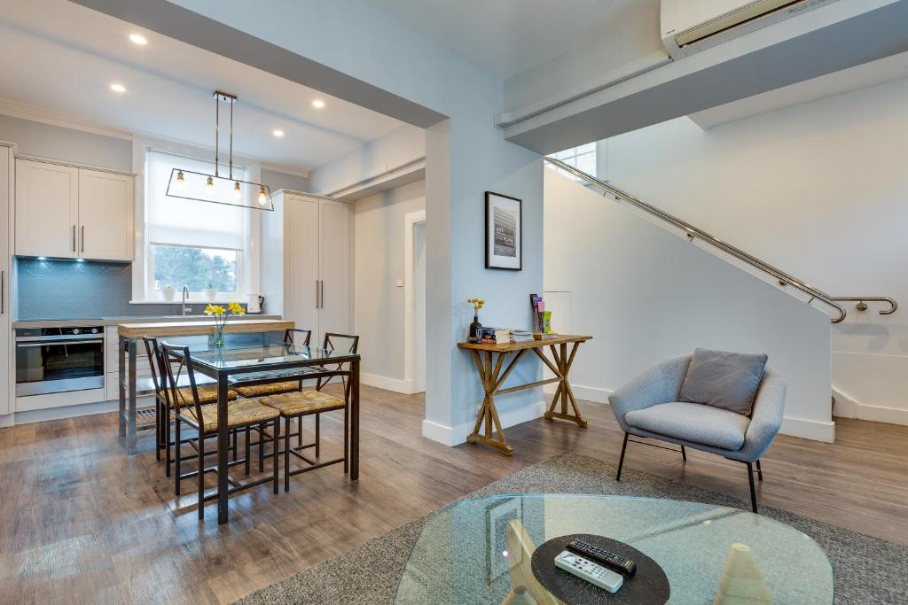 a kitchen and living room with a table and chairs at City Retreat Hobart in Hobart