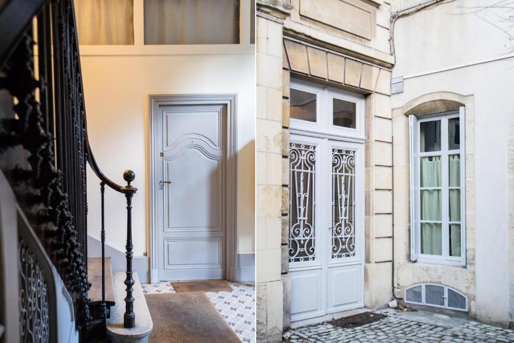 a white door on a building next to a window at Appartement Le Buffon in Dijon