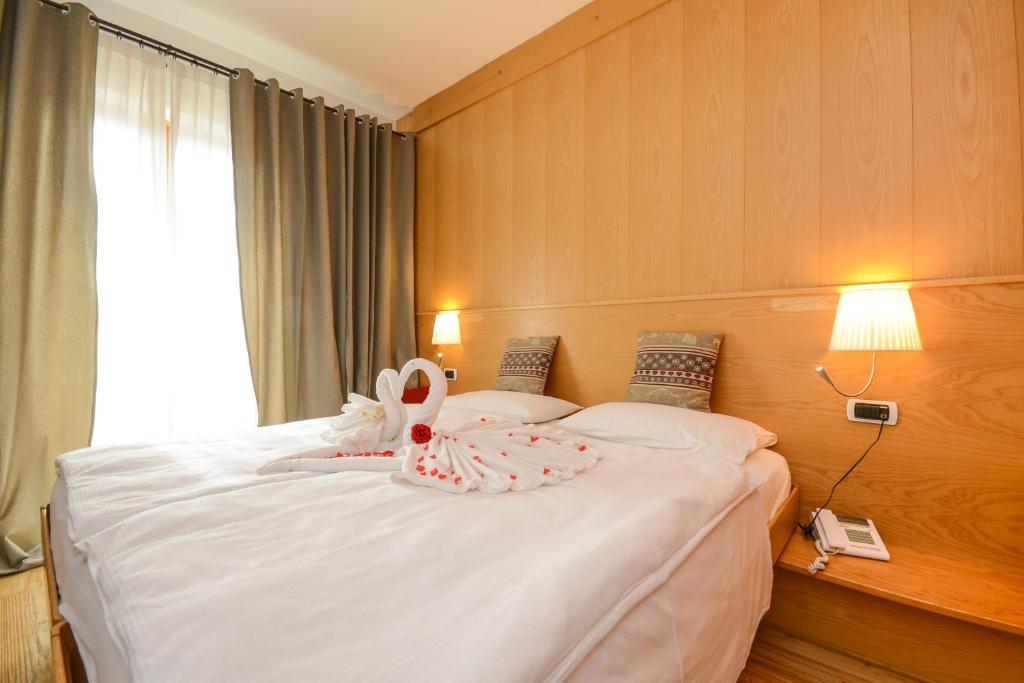 Postel nebo postele na pokoji v ubytování Hotel Corona