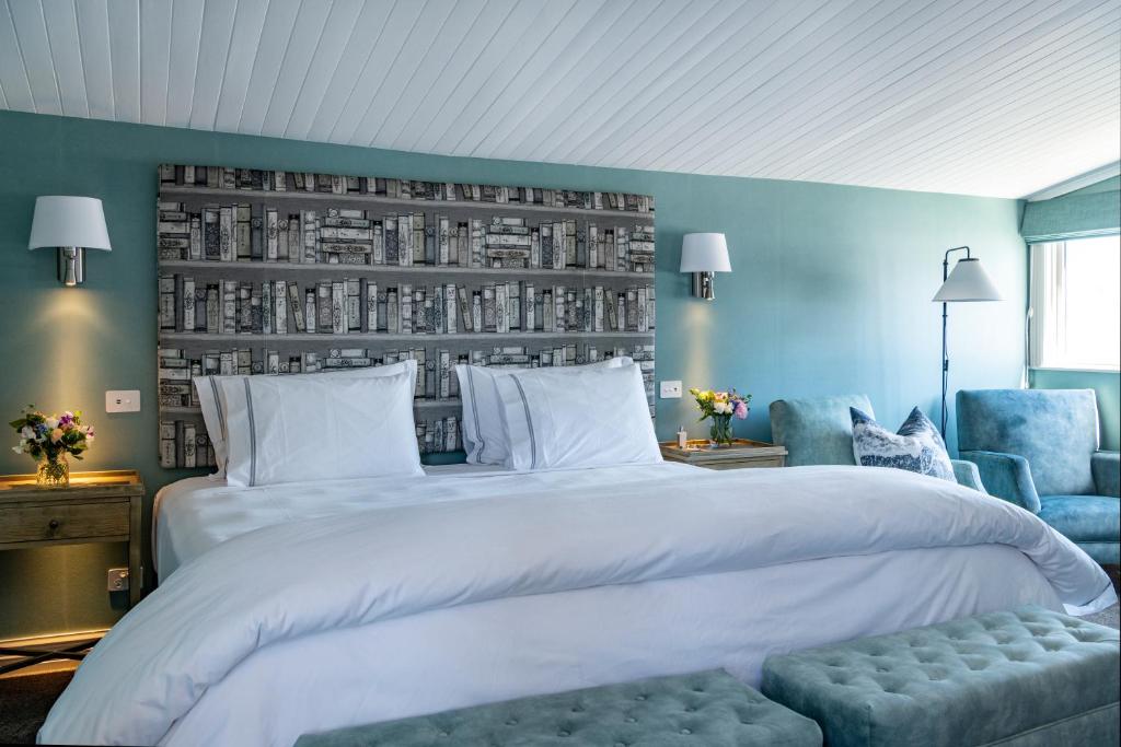 a bedroom with a large white bed and blue walls at 415 Marine Parade in Napier