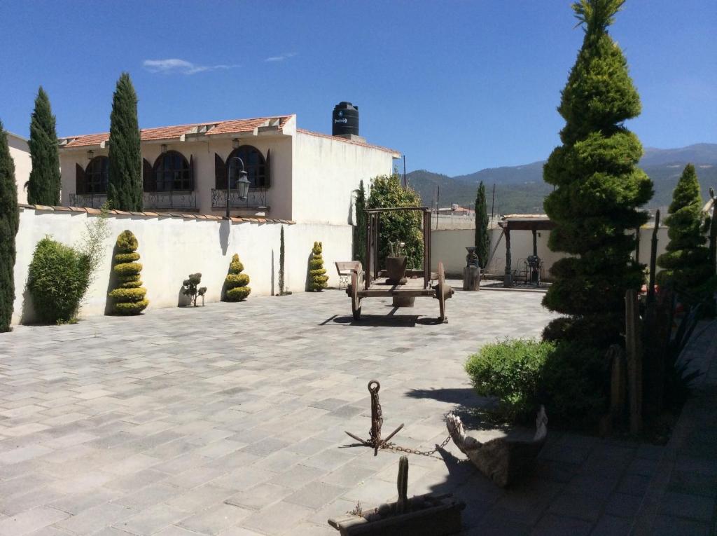 a courtyard with a building and a tree at Hosteria Covadonga in Perote