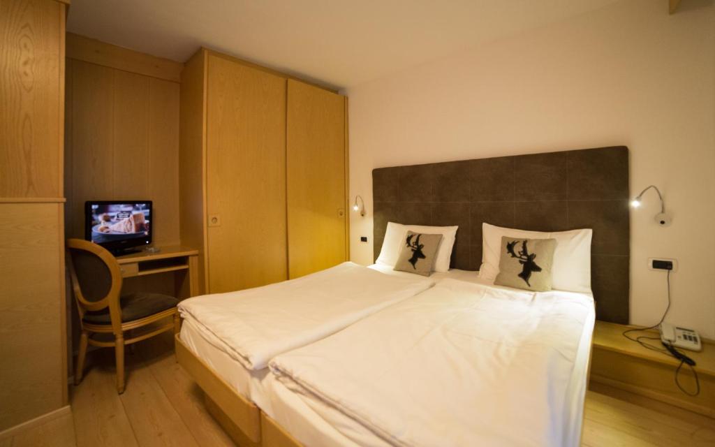 Postel nebo postele na pokoji v ubytování Hotel Corona