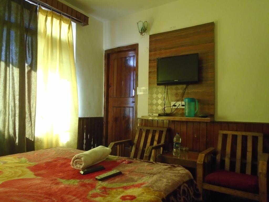 Postel nebo postele na pokoji v ubytování Hotel Magnolia Mallroad Manali