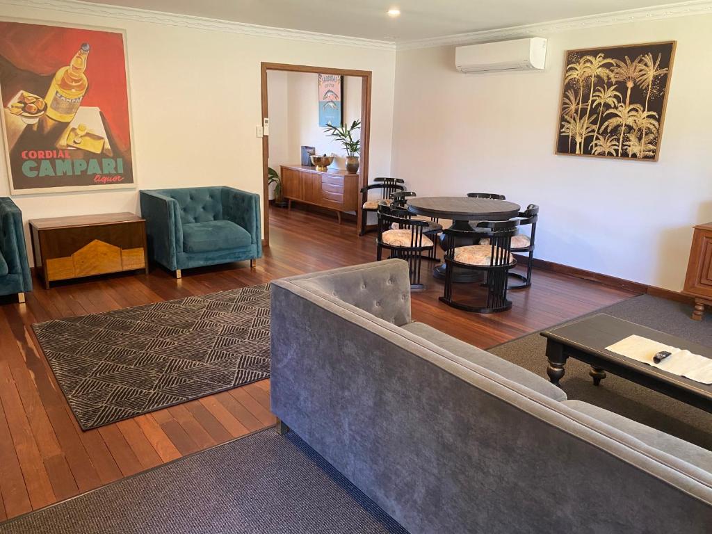 a living room with a couch and a table and chairs at Valley House in Margaret River Town