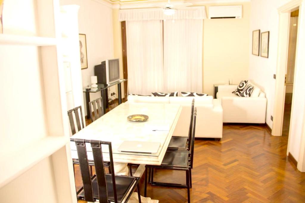 a living room with a table and chairs and a couch at Modern apartment in Boca Chica – 75 m² with air conditioning in Boca Chica