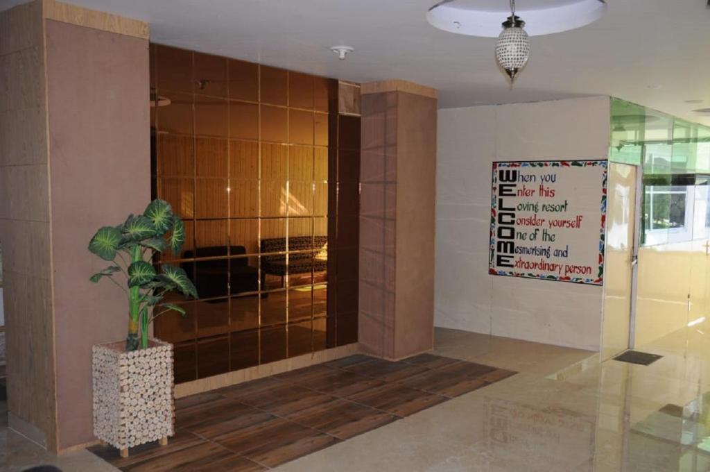 a lobby with a potted plant in a building at Flutter Hotels & Resorts in Lansdowne