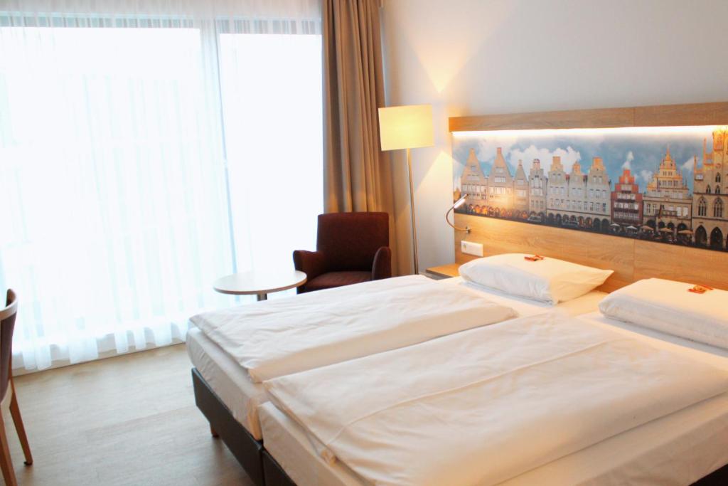 Postel nebo postele na pokoji v ubytování DRK-Tagungshotel-Dunant