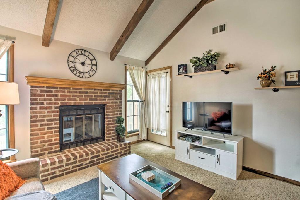 a living room with a fireplace and a tv at Shawnee Condo Less Than 10 Mi to Downtown Kansas City! in Shawnee