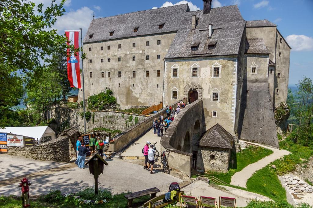 a castle with a bunch of people walking around it at Burg Altpernstein 